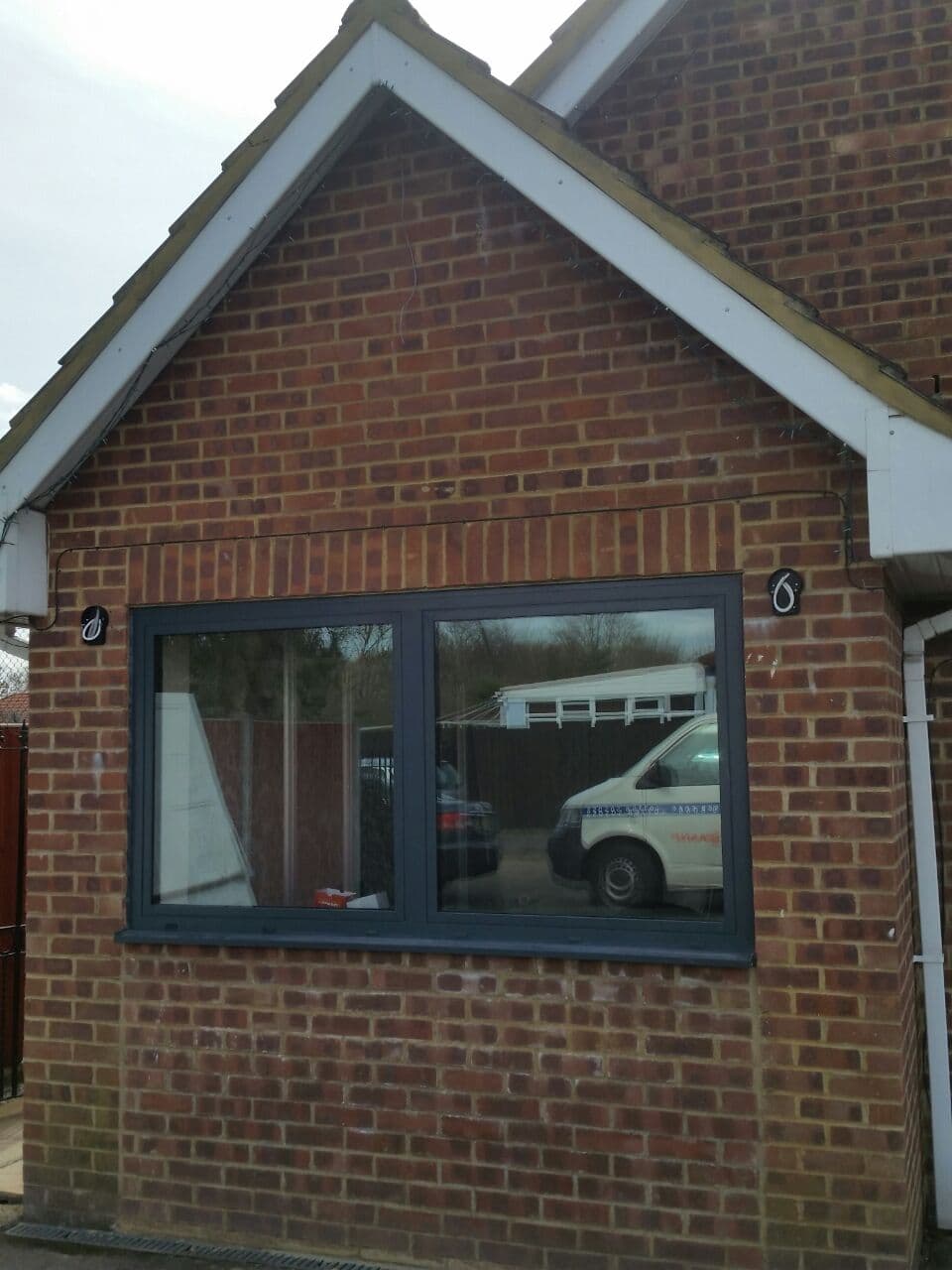 Flush casement windows on brick gable