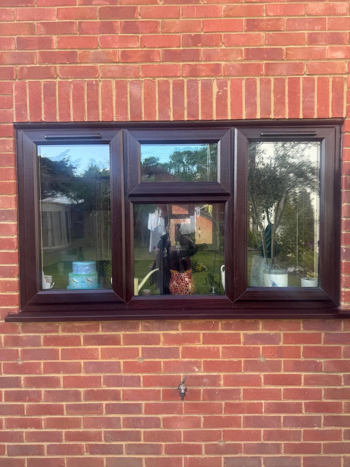 Rosewood uPVC casement window on red brick property