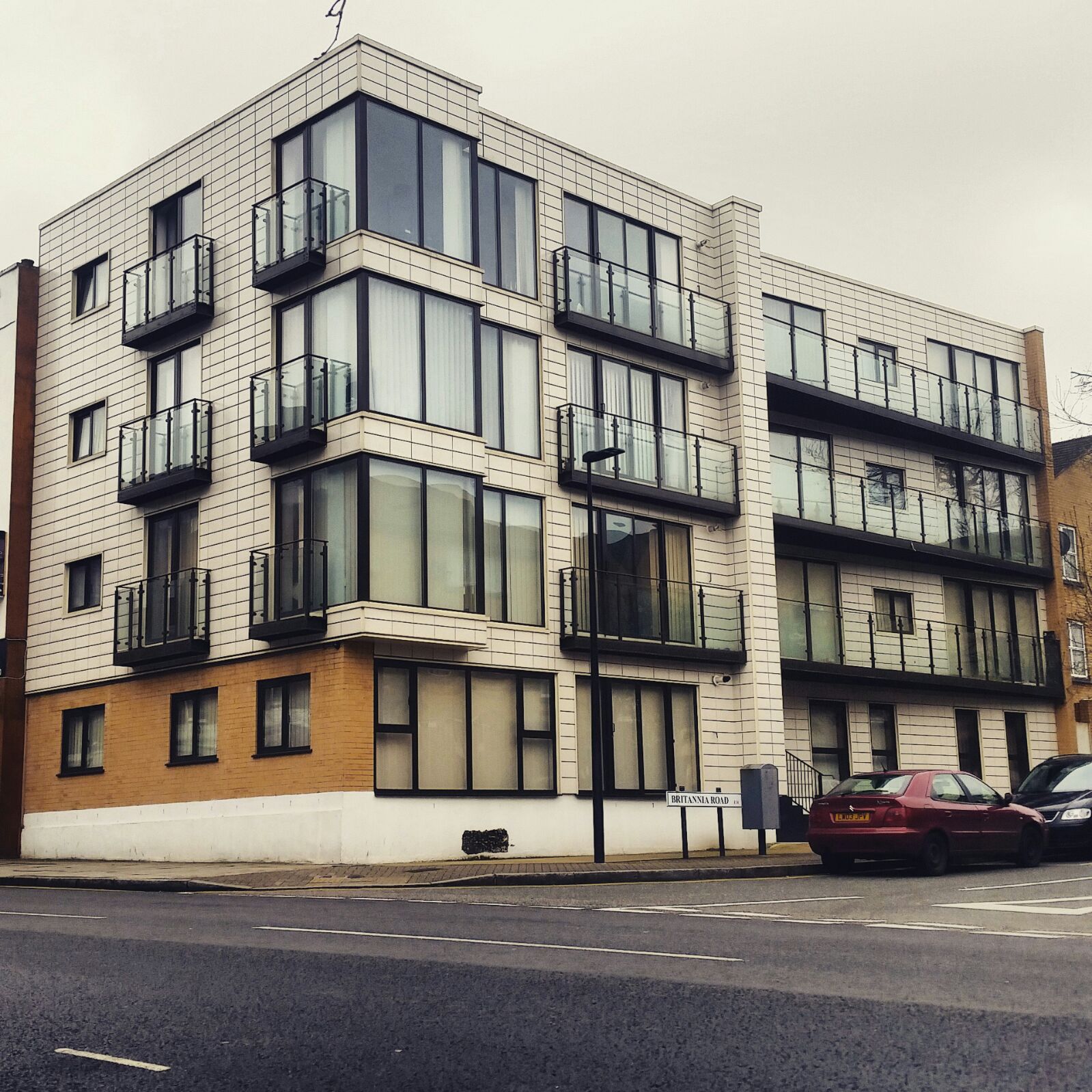 Modern apartment building with glass Juliet balconies